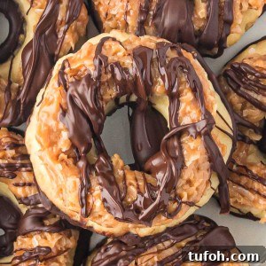 Homemade Samoa Cookies are a copycat version of everyone's favorite Girl Scout Cookie! These big, thick, and buttery shortbread cookies melt in your mouth and are packed with chocolate, caramel, and coconut.