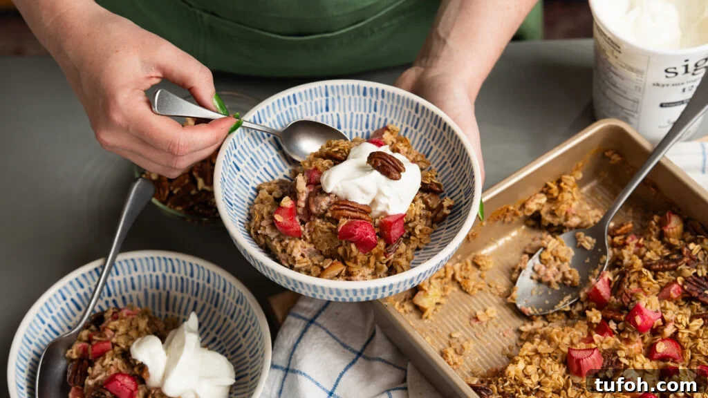 Rhubarb Baked Oats Recipe for Quick Morning Meals 9 Baked oats with rhubarb in a bowl with Greek yogurt.