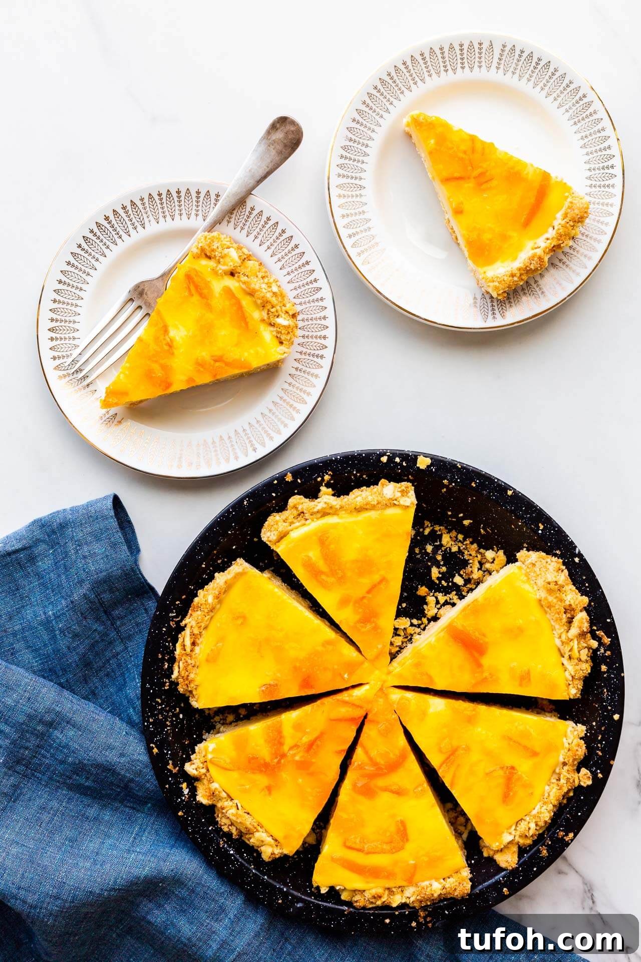 Zesty Orange Pie Recipe: Moist Citrus Tart with Fresh Orange Zest 9 Orange pie with saltine crust sliced and served on small dessert plates.