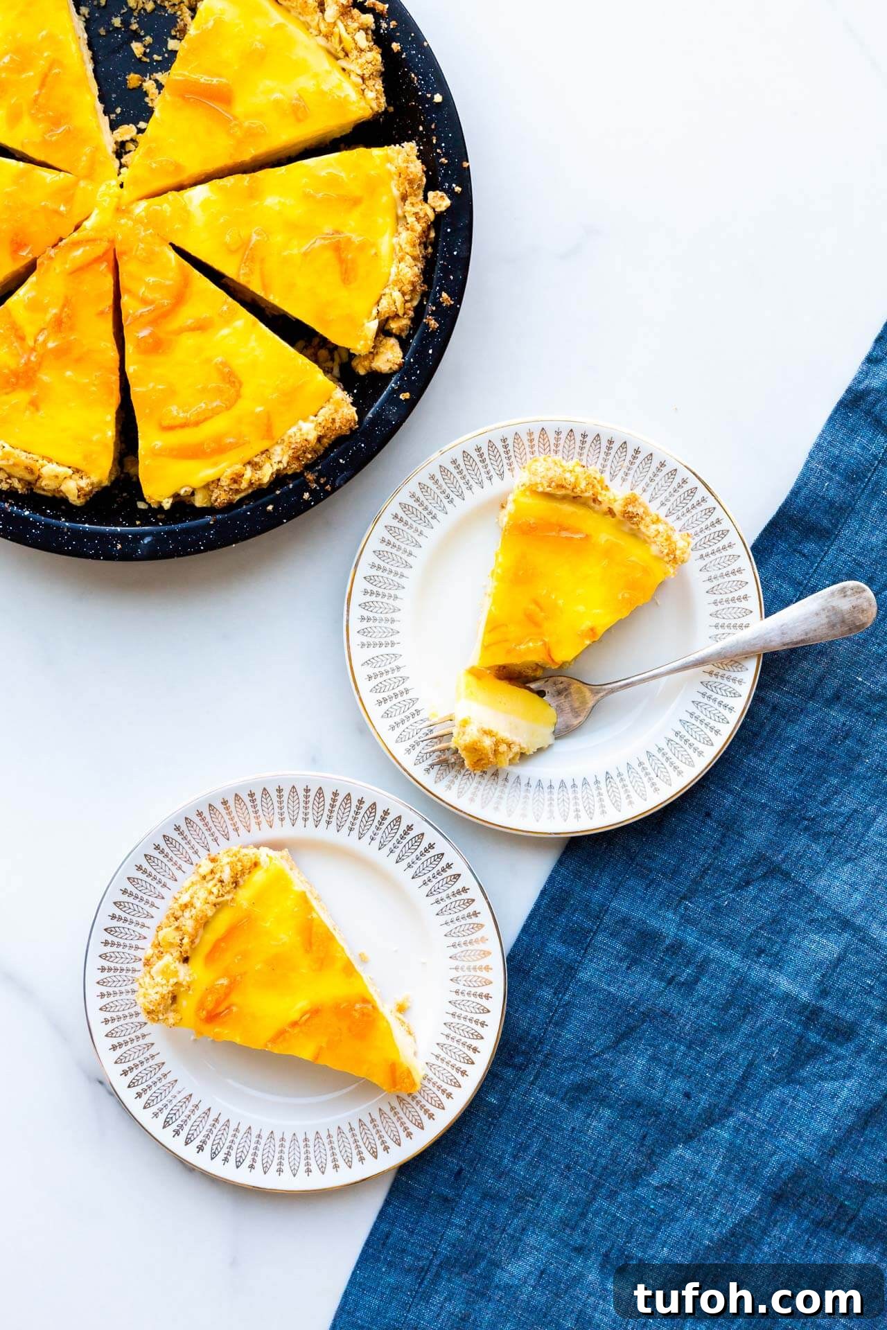 Zesty Orange Pie Recipe: Moist Citrus Tart with Fresh Orange Zest 10 Orange curd pie sliced and served on small dessert plates.