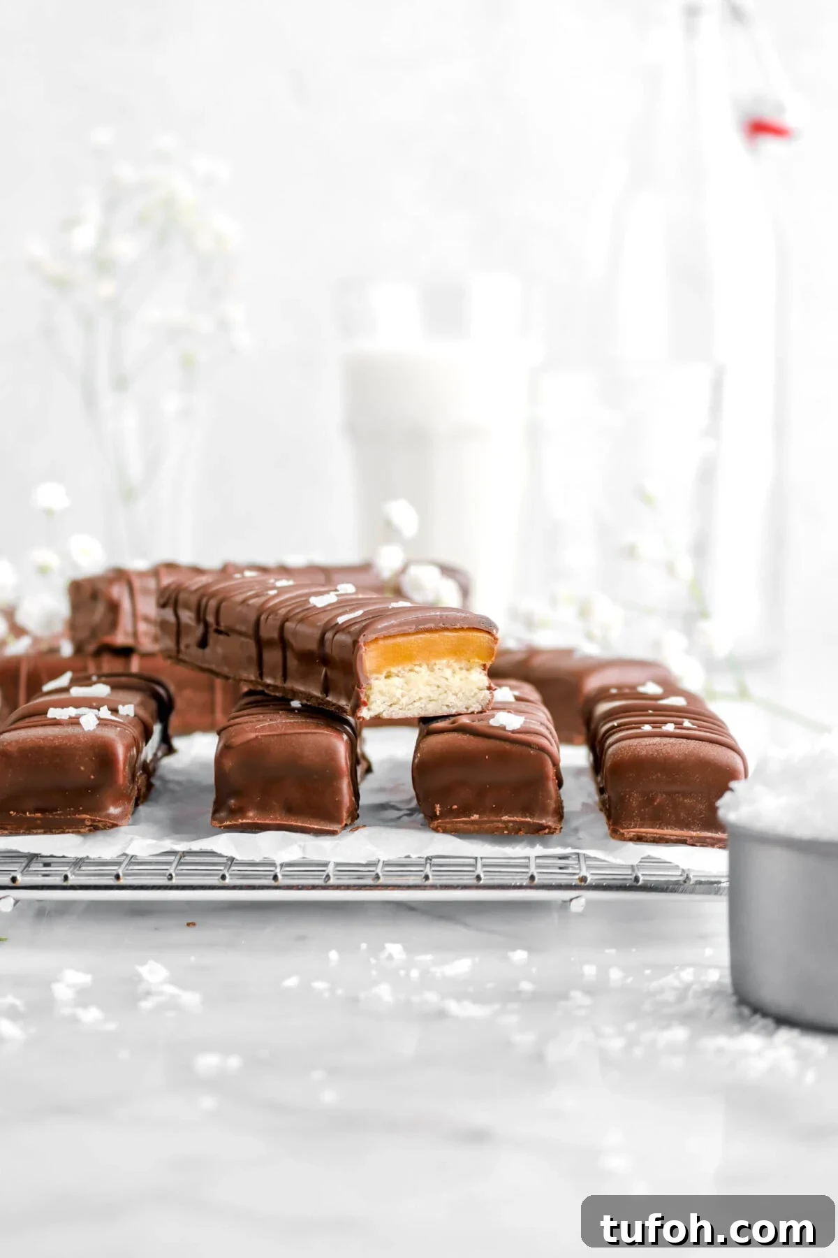 four twix bars on wire cooling rack with one stacked on top and cut open