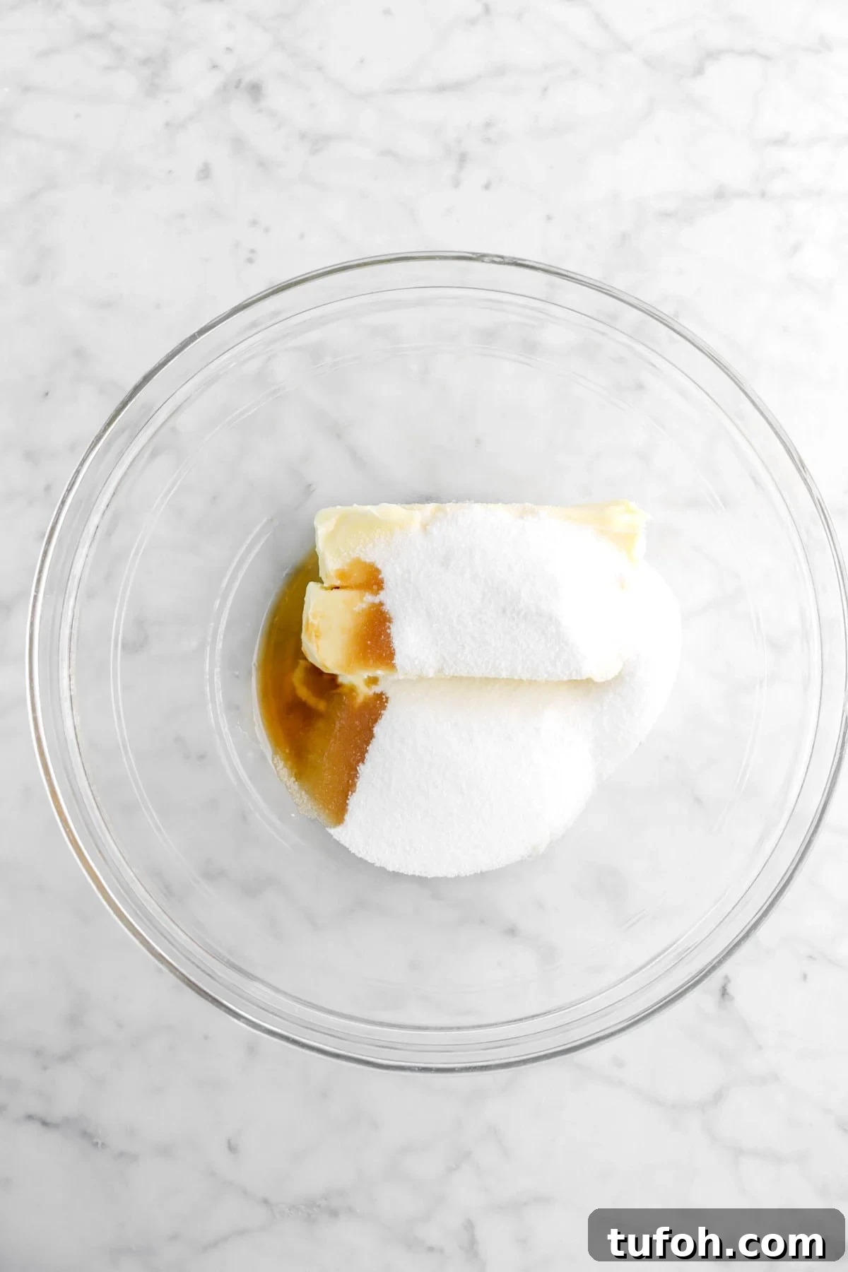 butter, sugar, flour, vanilla in glass bowl