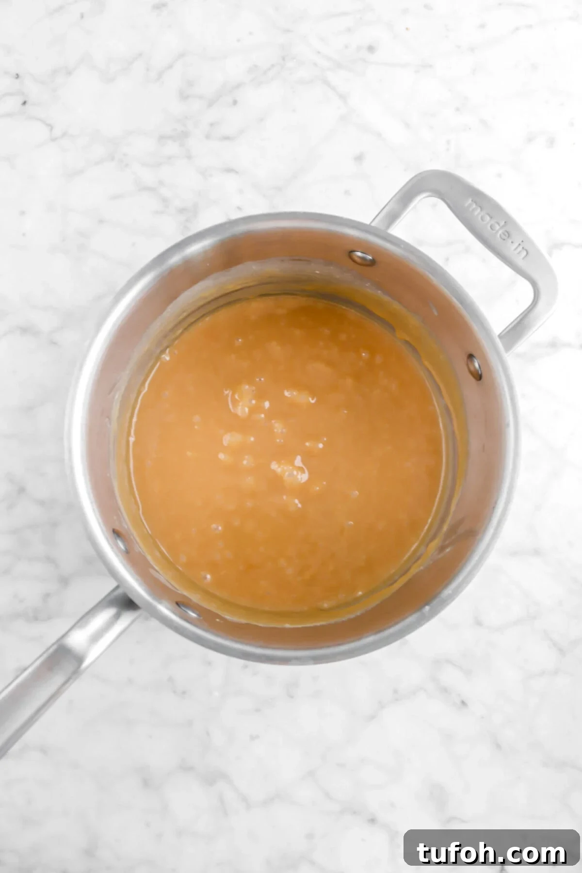 caramel in pot on marble surface