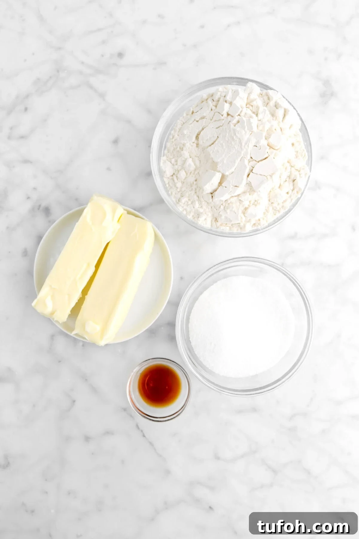 flour, butter, sugar, and vanilla on marble counter