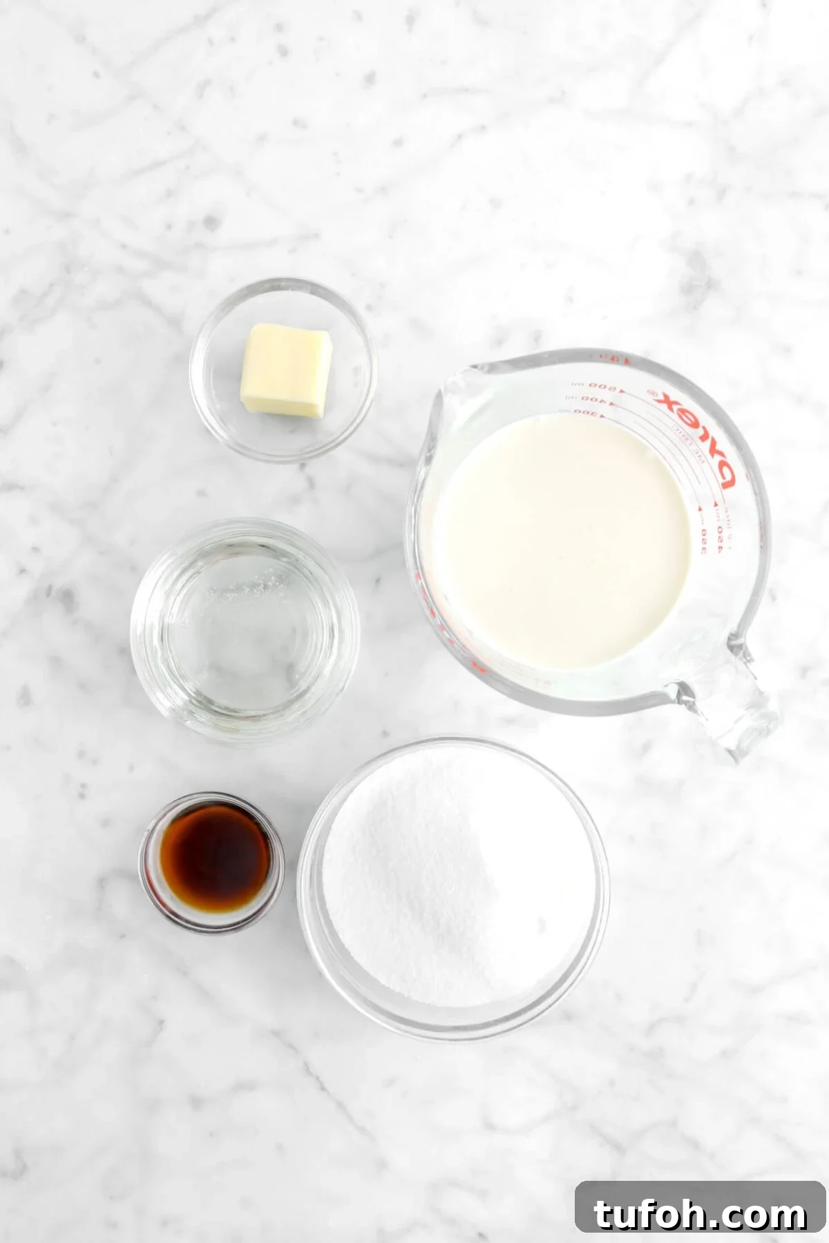 sugar, corn syrup, butter, milk, and vanilla on marble surface