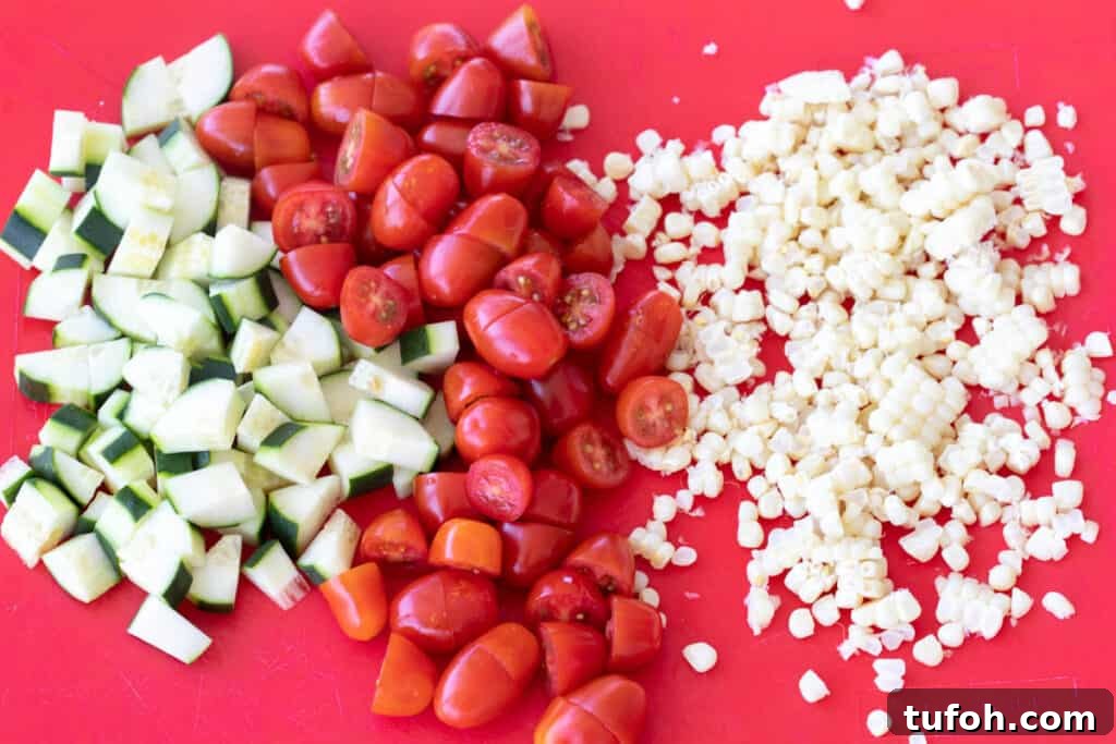 Summer Orzo (Risoni) Salad with Lemon & Fresh Herbs 5 chopped cucumber, cherry tomatoes, and corn off the cob on cutting board