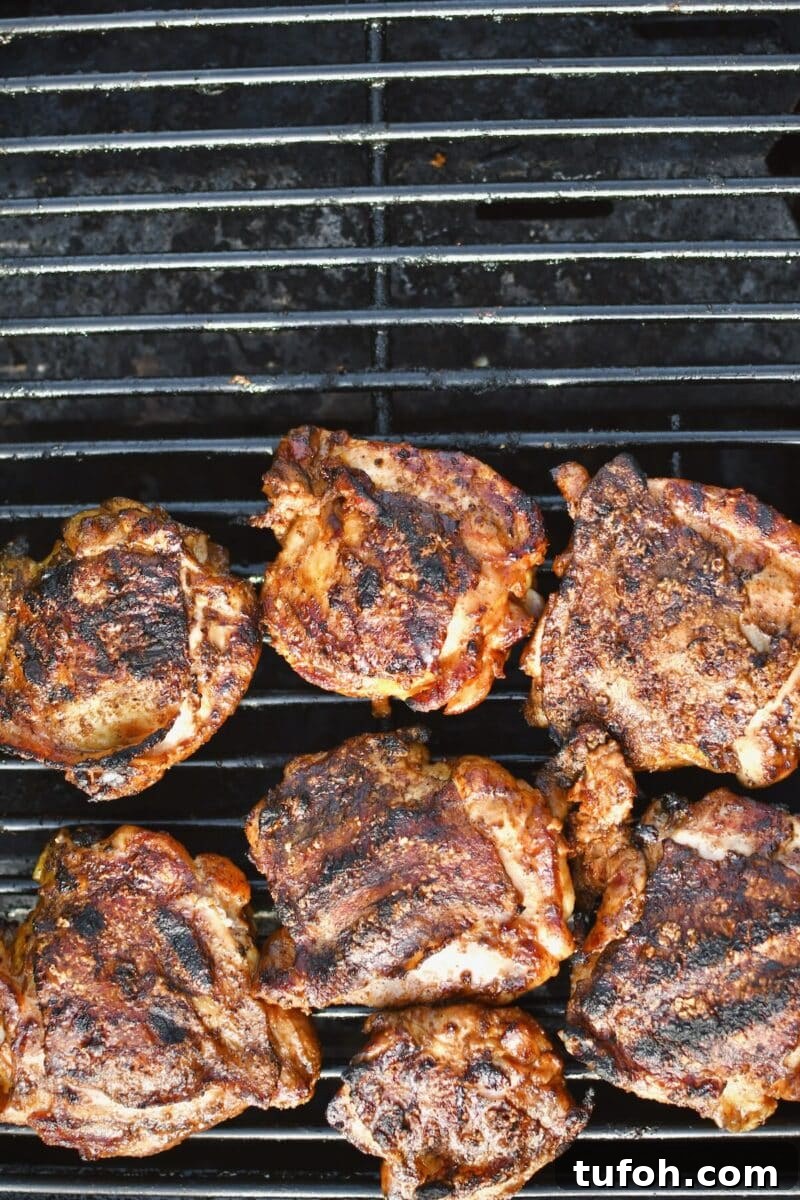 Juicy Grilled Chicken Thighs with Crispy Skin and Smoky Flavor 7 Chicken after crisping the skin, place on the off side of the grill to cook until 165˚F internal temp with the lid closed.