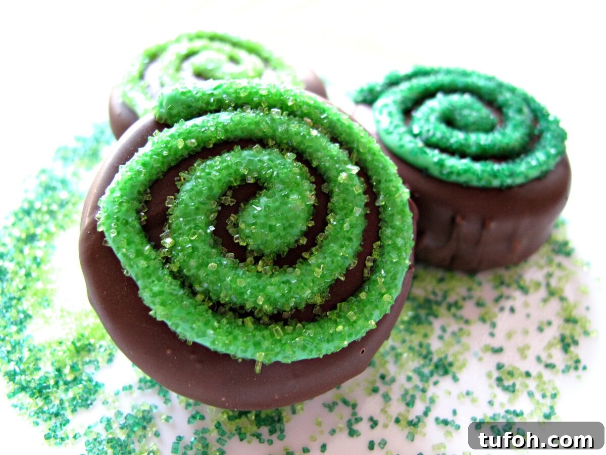St. Patrick’s Day Chocolate-Covered Oreo Treats 6 Closeup of swirl decorated chocolate coated cookies.