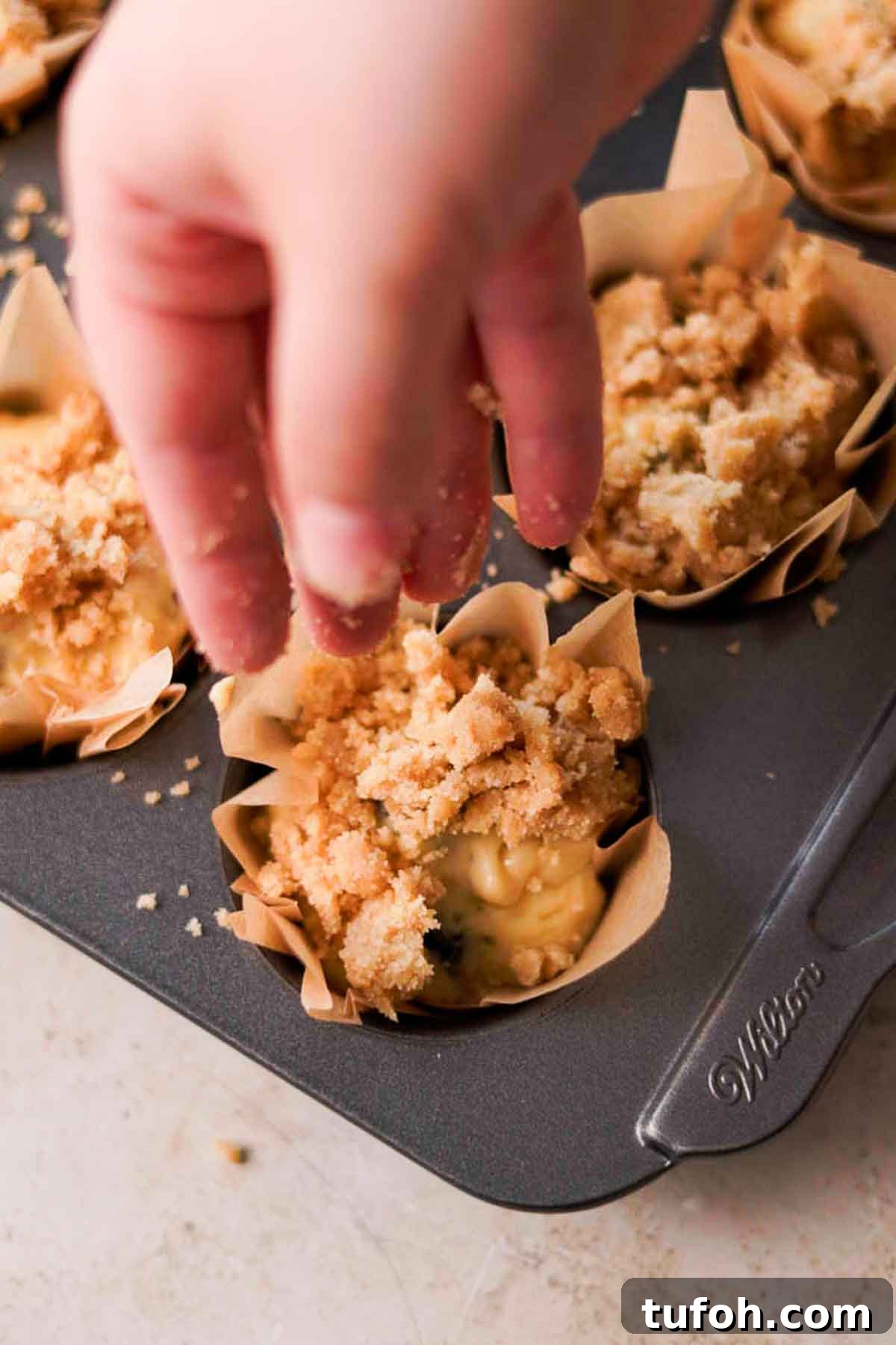 Irresistible Blackberry Muffin Recipe for Perfect Homemade Muffins 10 sprinkling crumble on top of muffin batter