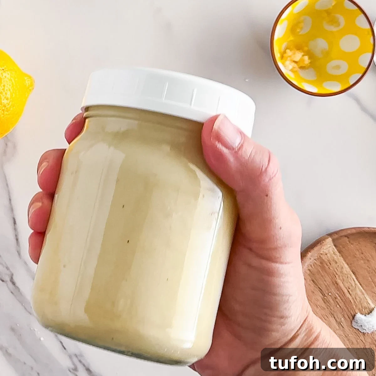 Creamy Tahini Dressing Recipe for Salads and Bowls 5 Shaking the jar of dressing.