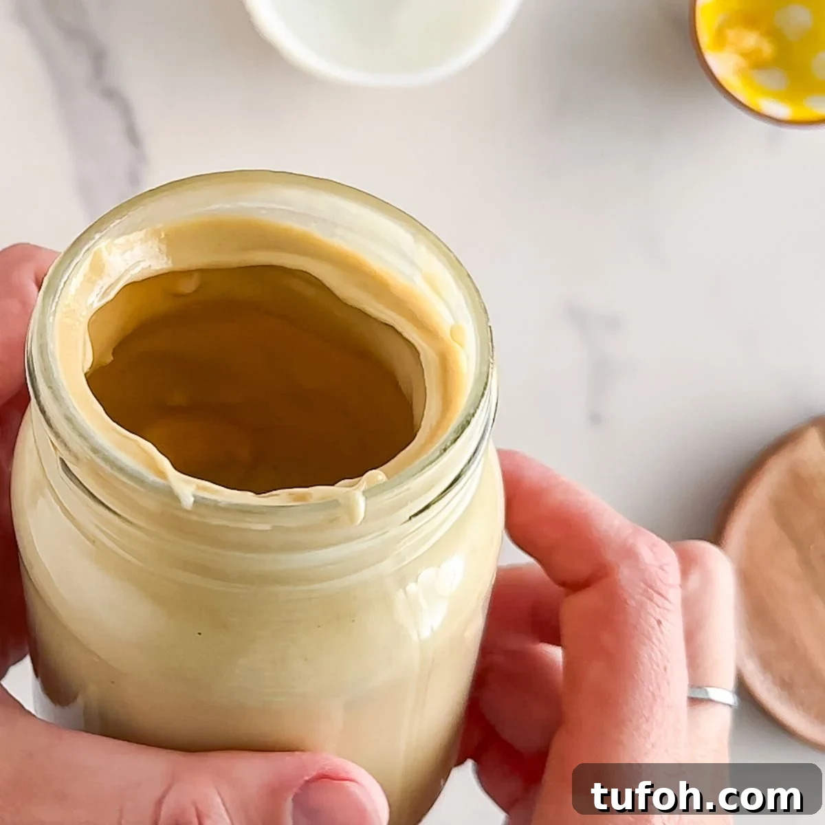 Creamy Tahini Dressing Recipe for Salads and Bowls 6 Checking the texture of the dressing.