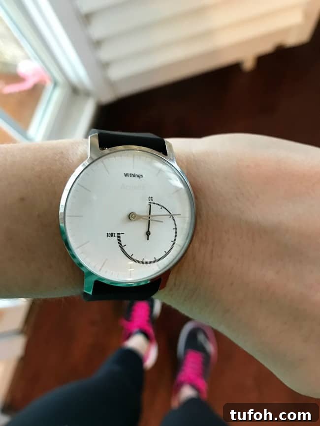 A close up of a fitness watch on a woman's wrist.