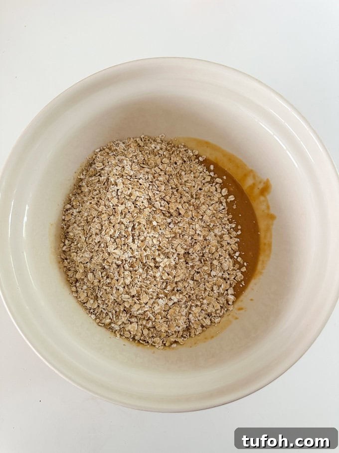 Peanut Butter Chocolate Flapjack Recipe — Chewy Oaty Bars 4 Ingredients in a mixing bowl.