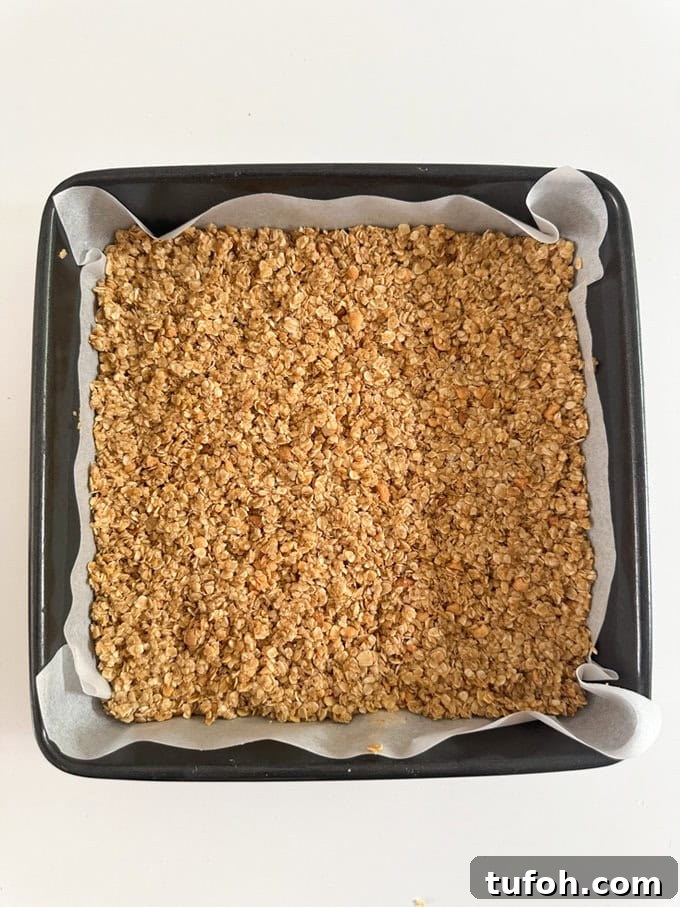 Peanut Butter Chocolate Flapjack Recipe — Chewy Oaty Bars 5 Ingredients added to a deep baking tray.