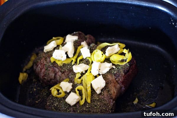 Pot roast ready to cook with pepperoncini and butter. Ranch Pot roast before cooking