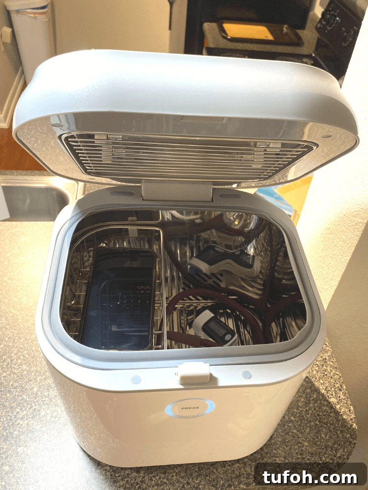 Sanitize and Sterilize Your Belongings Safely and Effectively 3 Our open UV sanitizer with a cell phone as well as healthcare tools like a pulse oz and stethoscope inside it.