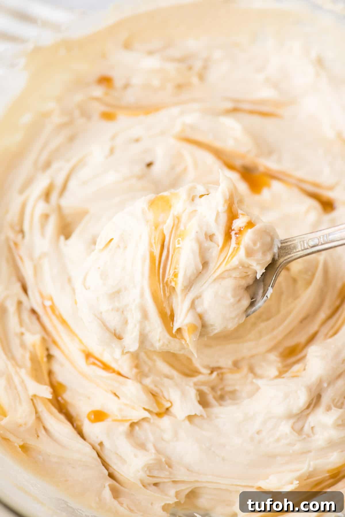 Silky Salted Caramel Frosting Recipe for Cakes & Cupcakes 2 salted caramel frosting on metal spoon