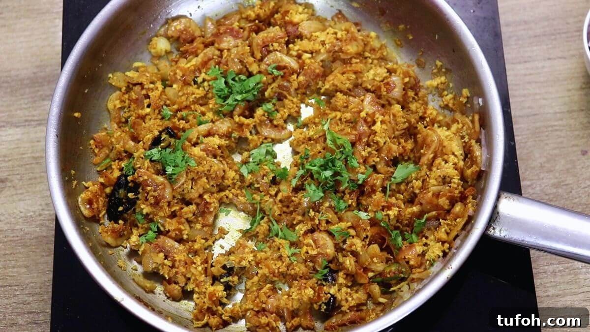 garnishing prawns kismoor with coriander leaves.