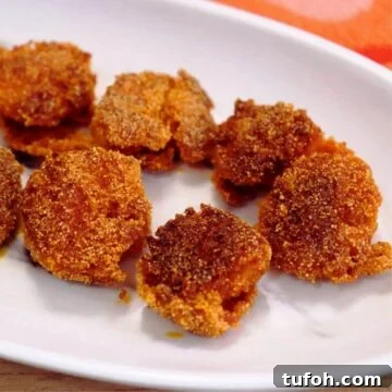 goan prawns rava fry served on a white plate.