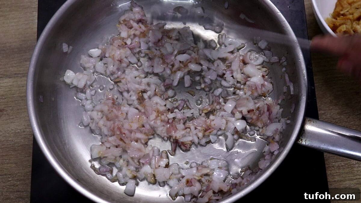 Sauté onions to make prawns kismoor.