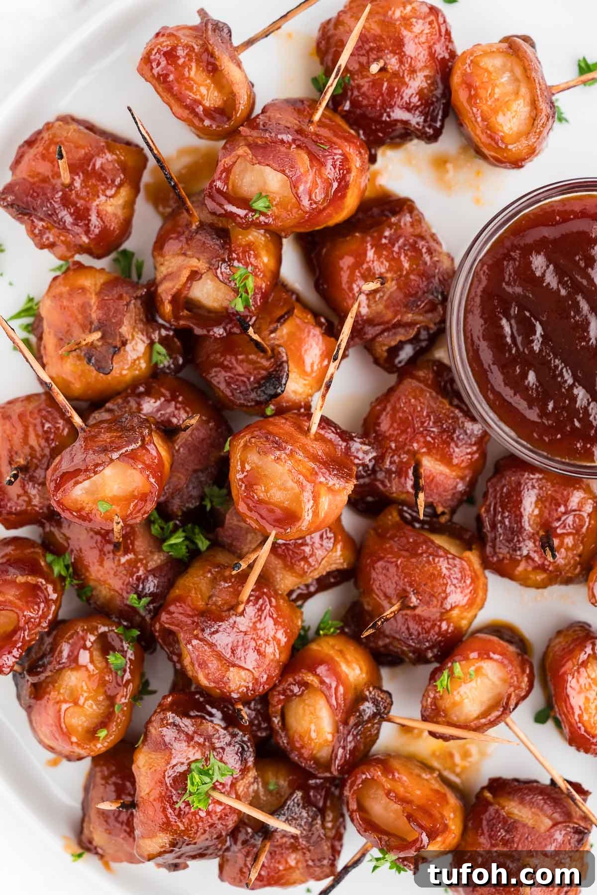 Crispy Bacon-Wrapped Water Chestnuts (Sweet & Savory Appetizer) 11 appetizers on a plate with sauce