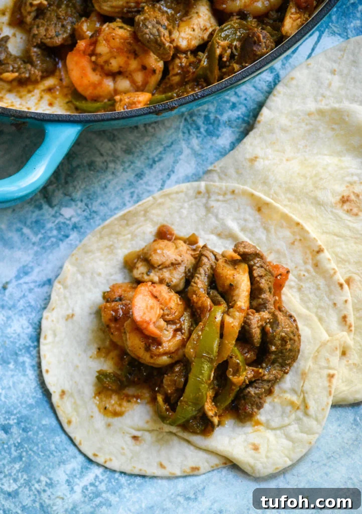 steak, chicken & shrimp fajita filling piled on a soft flour tortilla