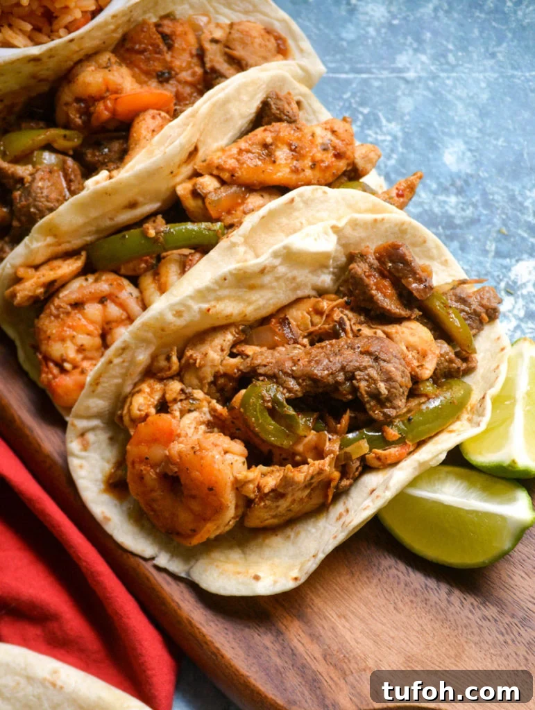 Texas fajitas arranged on a narrow wooden cutting board with a small bowl of spanish rice