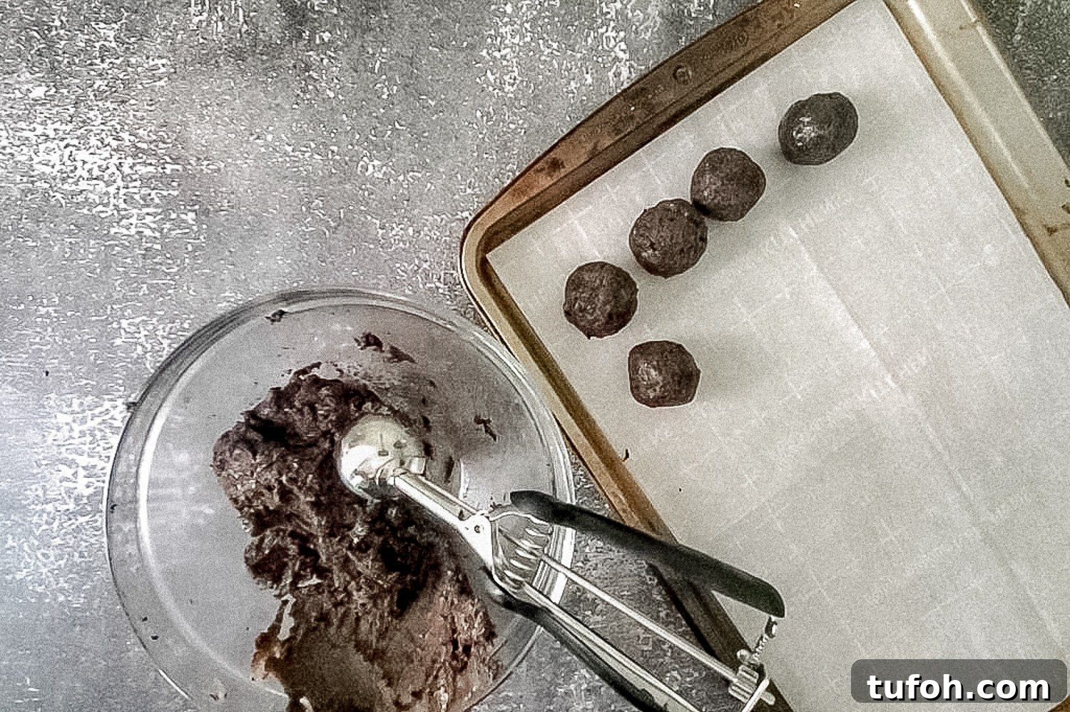 cookie sheet with bowl and scoops of filling 