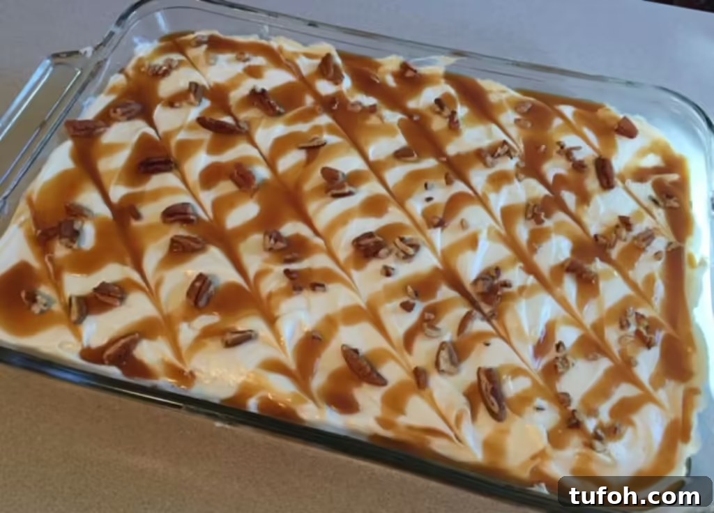 Classic Danish Apple Cake Recipe You’ll Love 6 Pan of frosted Danish apple cake swirled with caramel and garnished with pecans, perfect for fall gatherings.