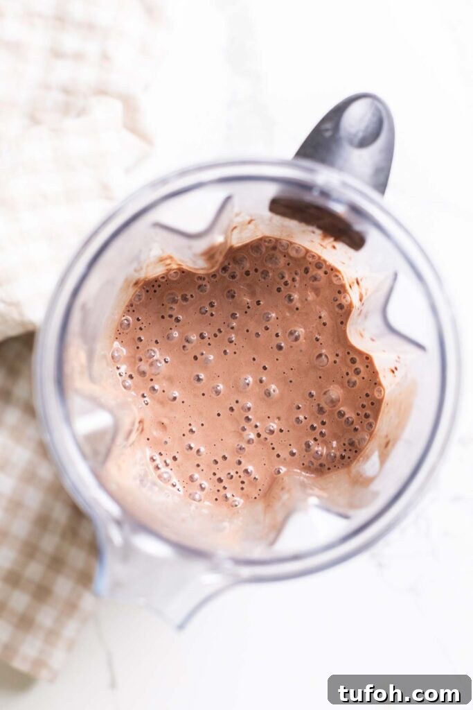 A chocolate ice cream base shown mixed together in a blender.