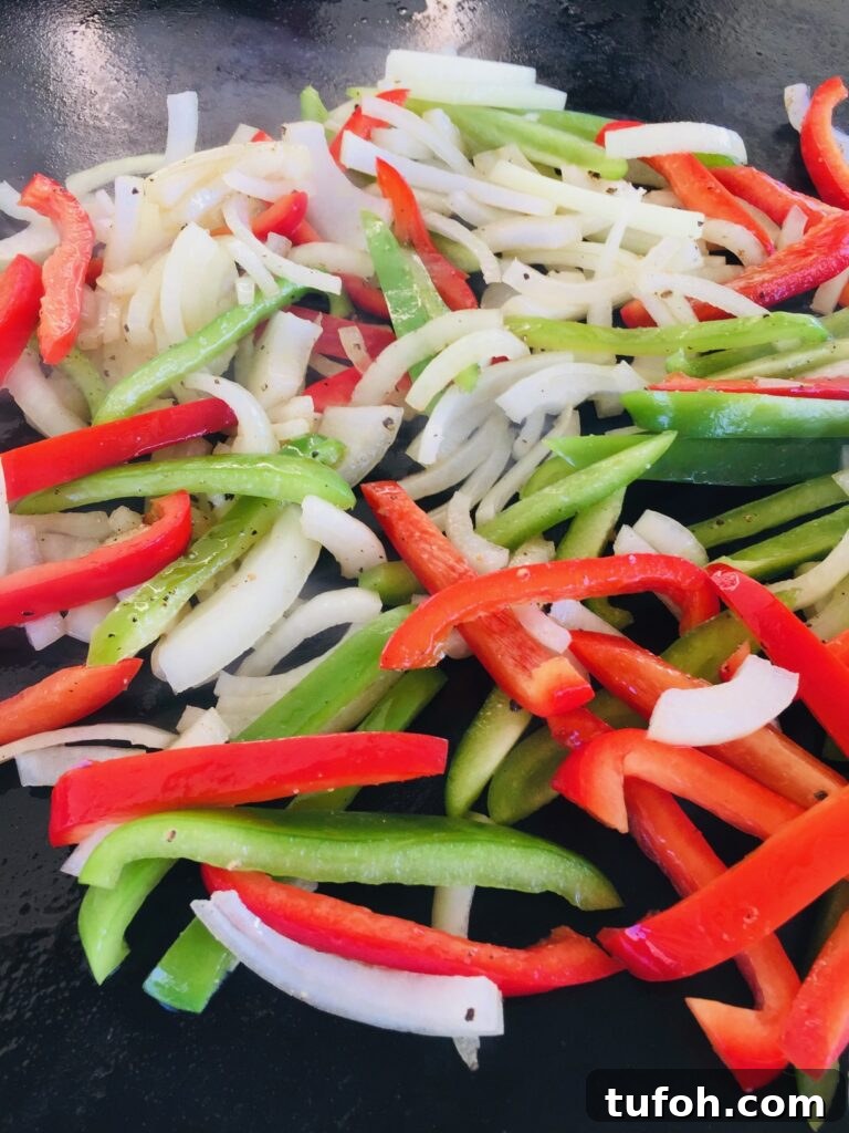 adding peppers and onions to Blackstone