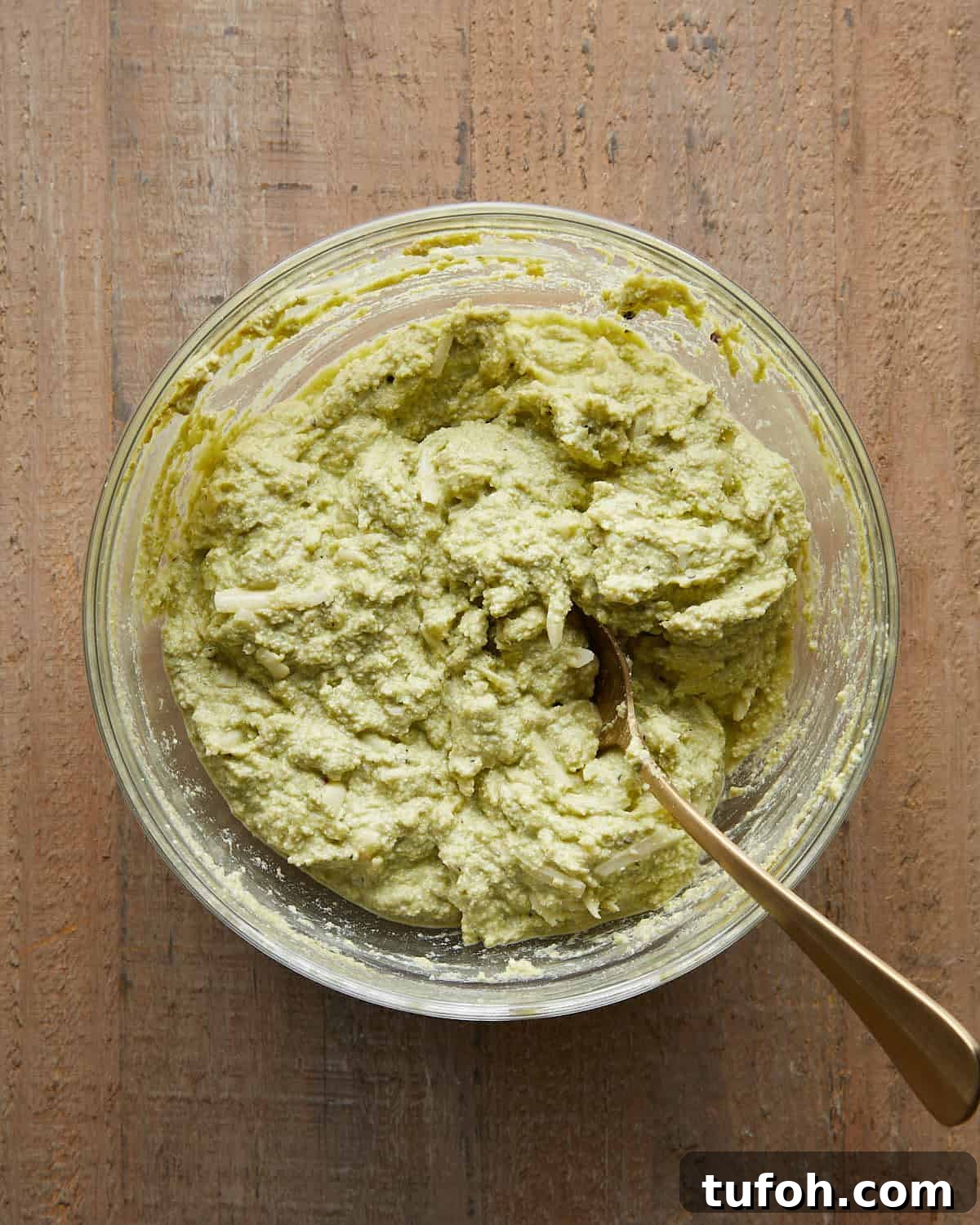 Ricotta and pesto mixture prepared to stuff shells for baked stuffed shells recipe.
