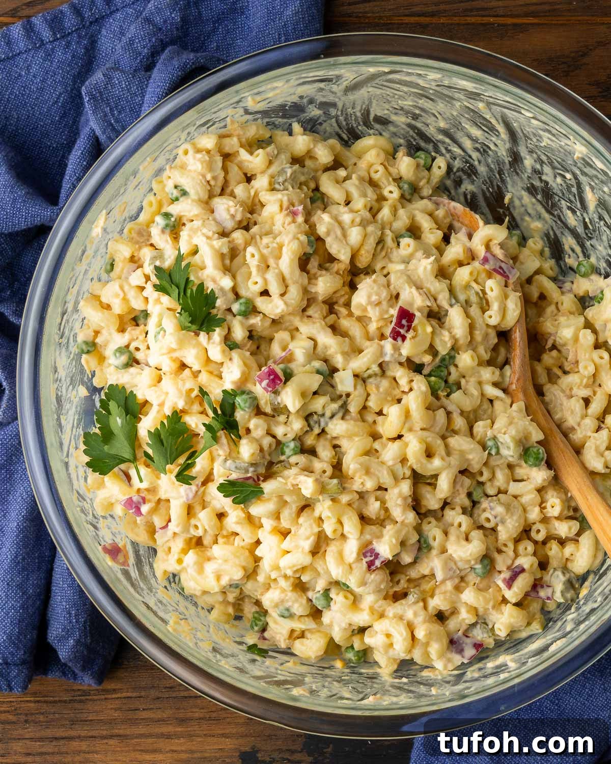 Creamy Tuna Macaroni Salad with Zesty Herb Dressing 2 Tuna macaroni salad in glass bowl with blue napkins on the side.