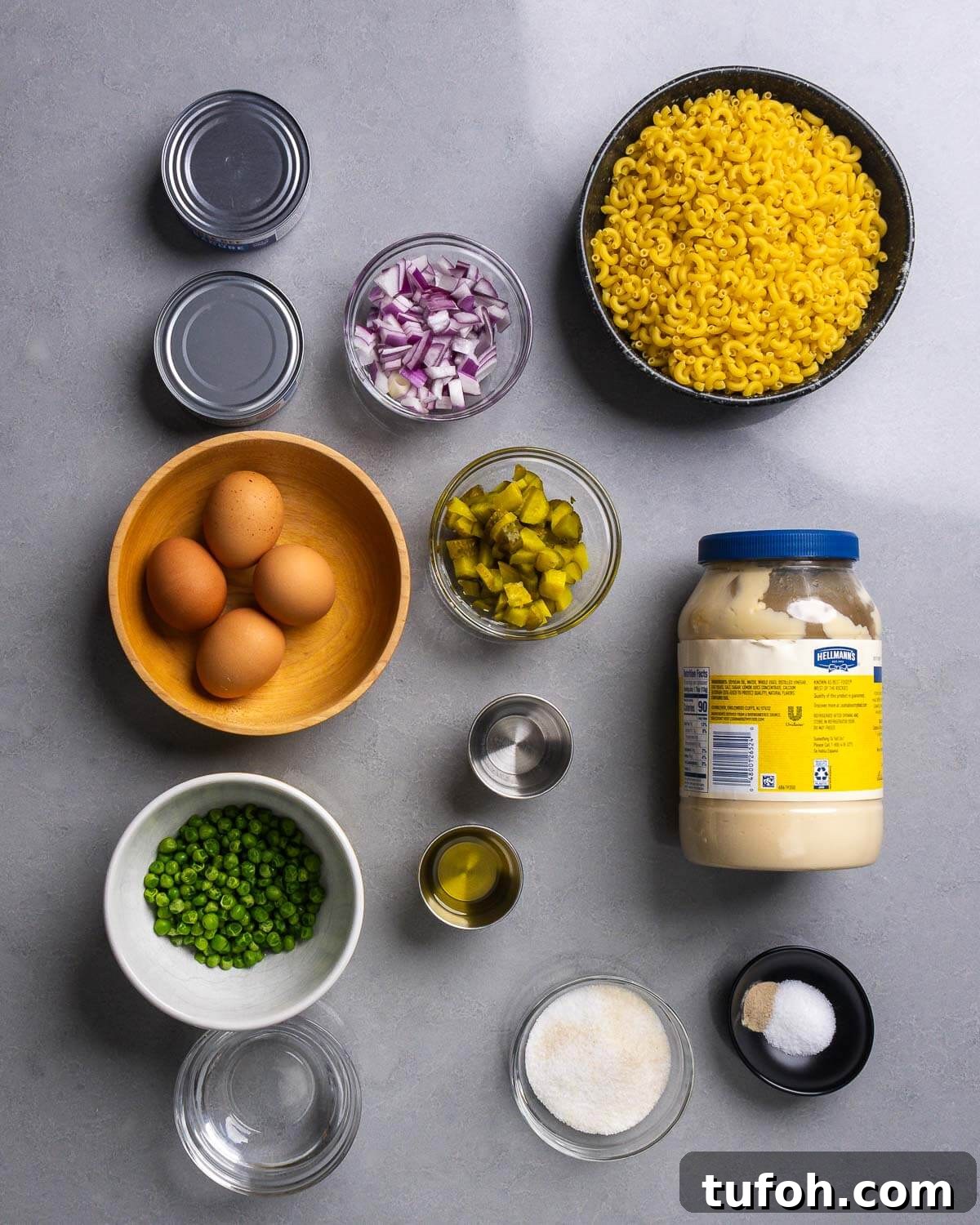 Creamy Tuna Macaroni Salad with Zesty Herb Dressing 4 Ingredient shown: canned tuna, red onion, elbow macaroni, eggs, dill pickles, peas, oil, vinegar, mayonnaise, water, sugar, salt, and pepper.