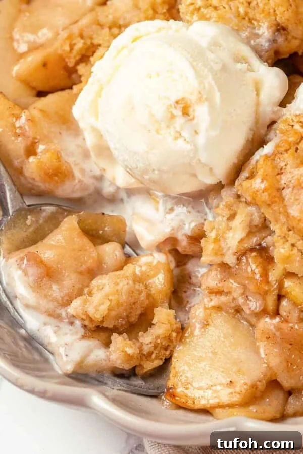 Flaky Apple Cinnamon Rolls with Brown Sugar Glaze 10 A scoop of vanilla ice cream melting on warm apple cobbler.