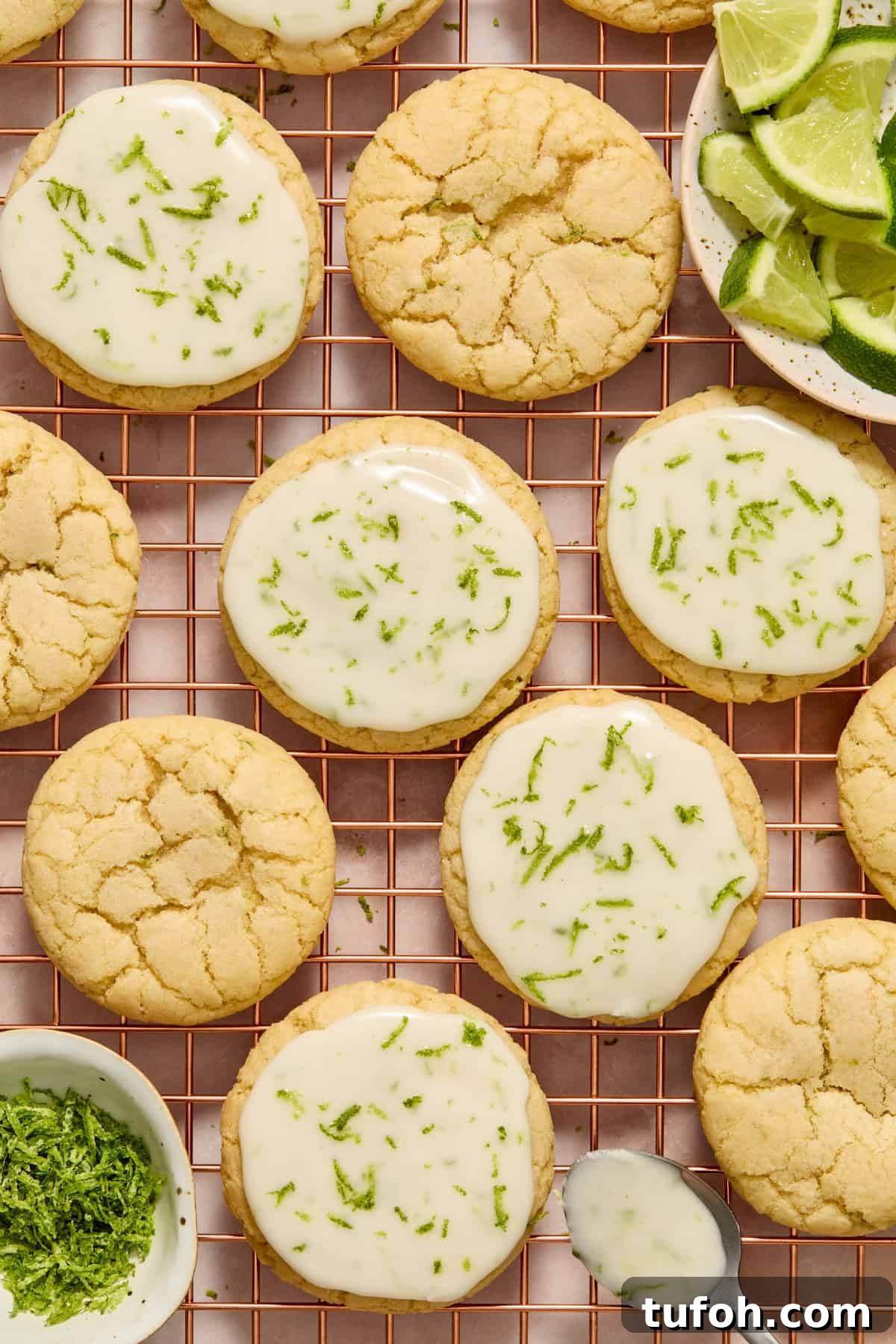 Cookies on cooling rack with icing on spoon and some cookies iced and others not.