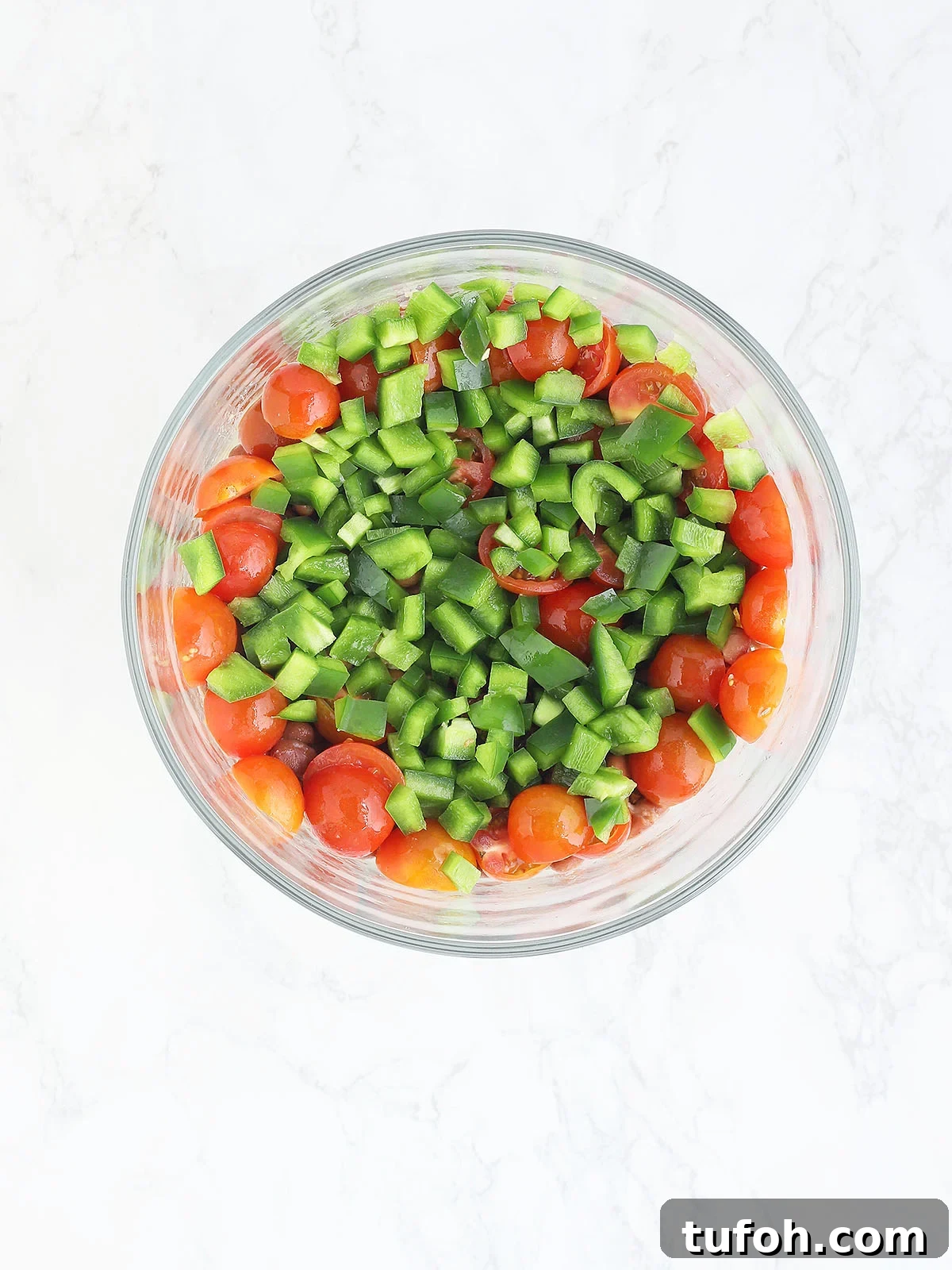 cornbread salad topped with diced green bell peppers