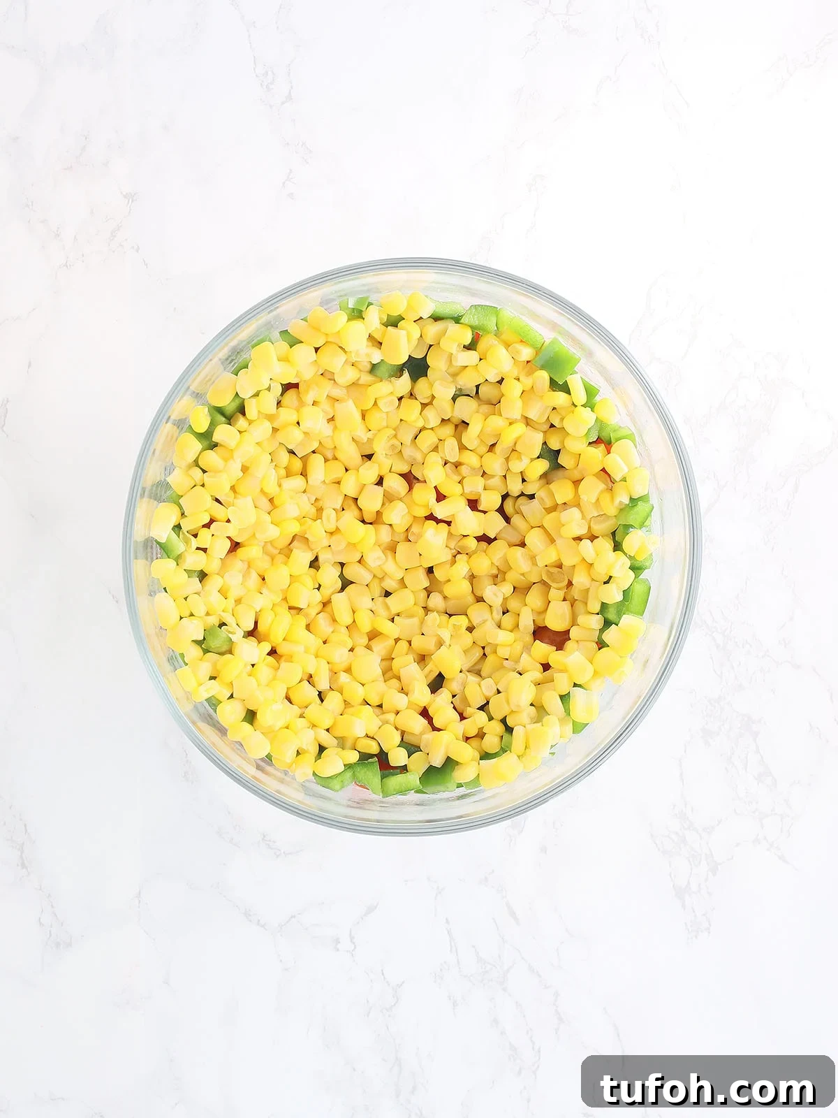 cornbread salad topped with whole kernel corn