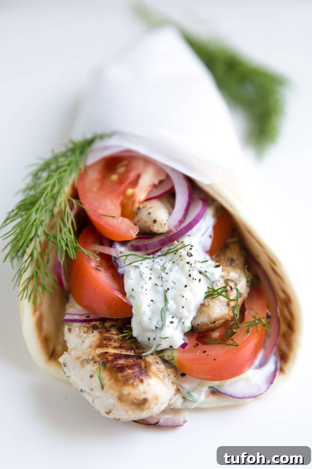 Marinated chicken, sliced tomatoes, red onion, fresh dill, and creamy tzatziki all wrapped in a soft pita flatbread.