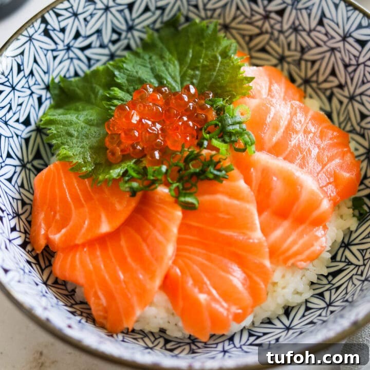 Closeup of salmon sashimi rice bowl with Ikura.