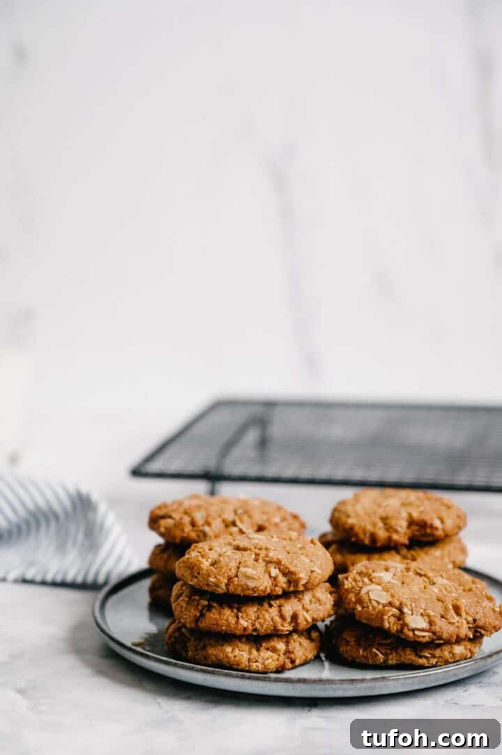 a pile of Anzac biscuits on a grey plate.