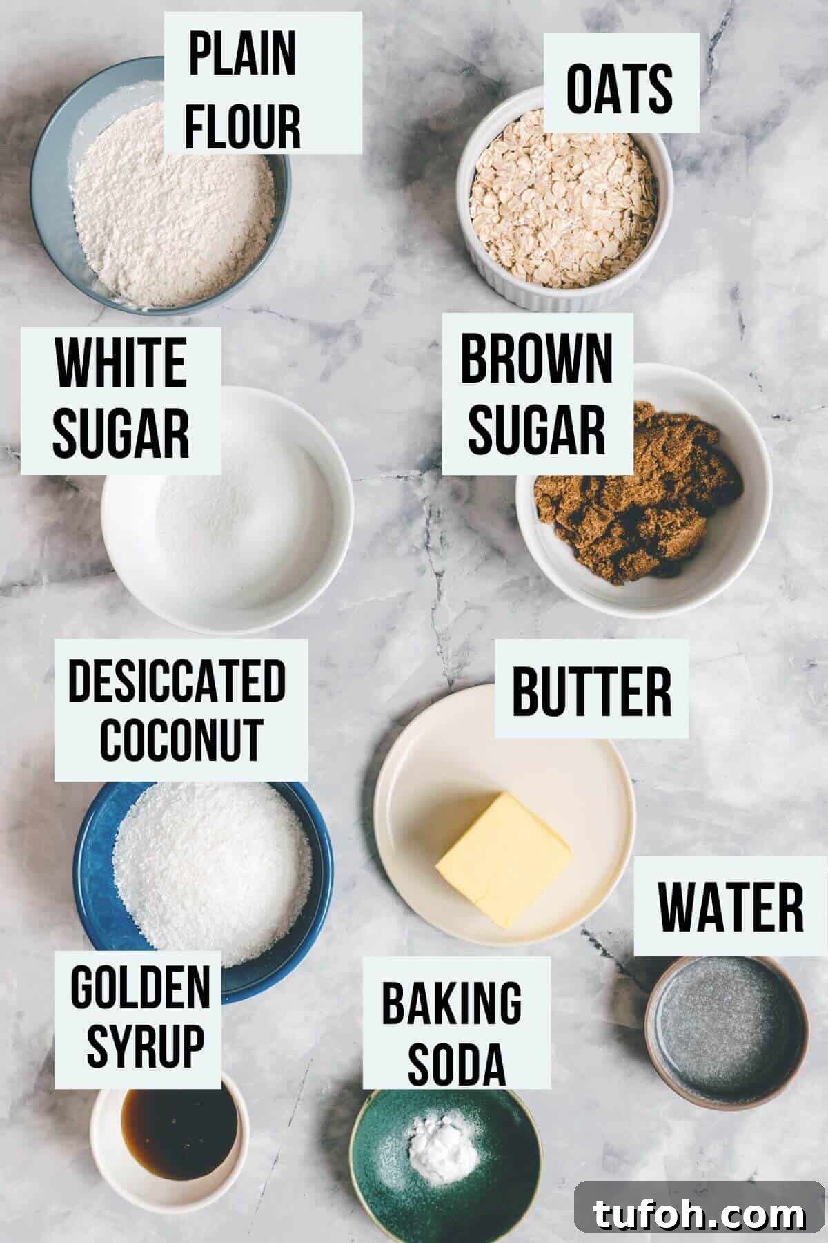 ingredients to make Anzac biscuits on a marble table.