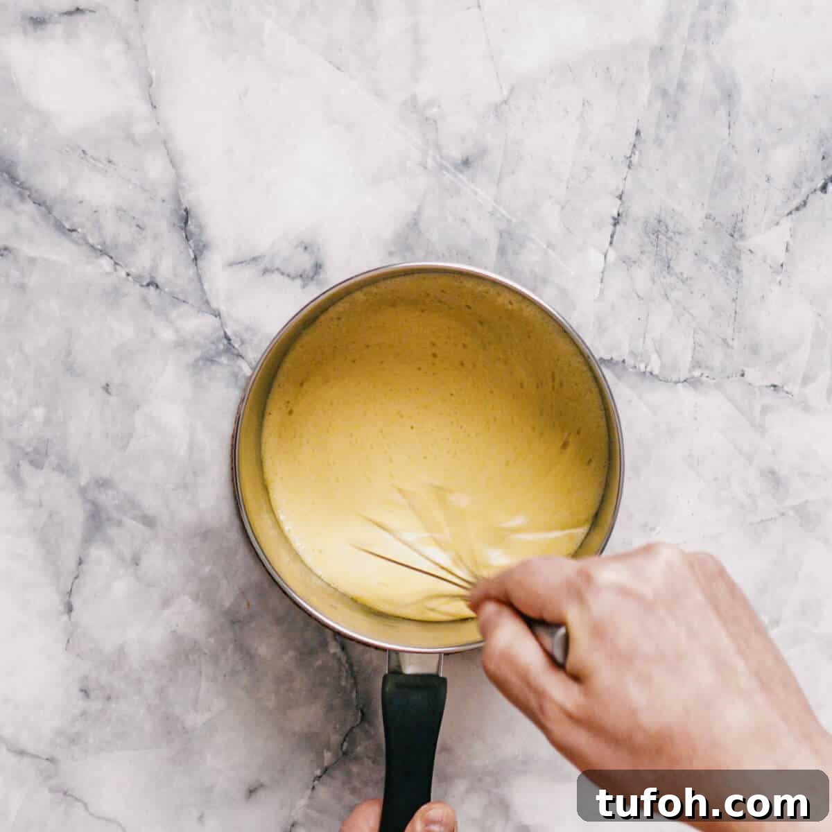 whisking baking soda with butter and golden syrup in a saucepan.