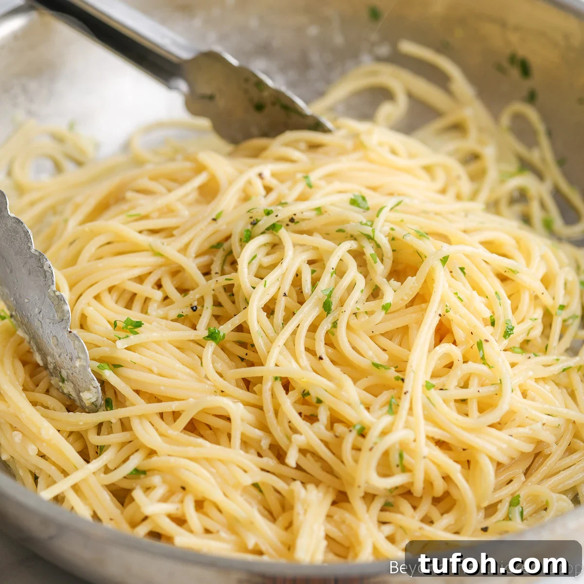 Pasta sprinkled with parsley in a pan.