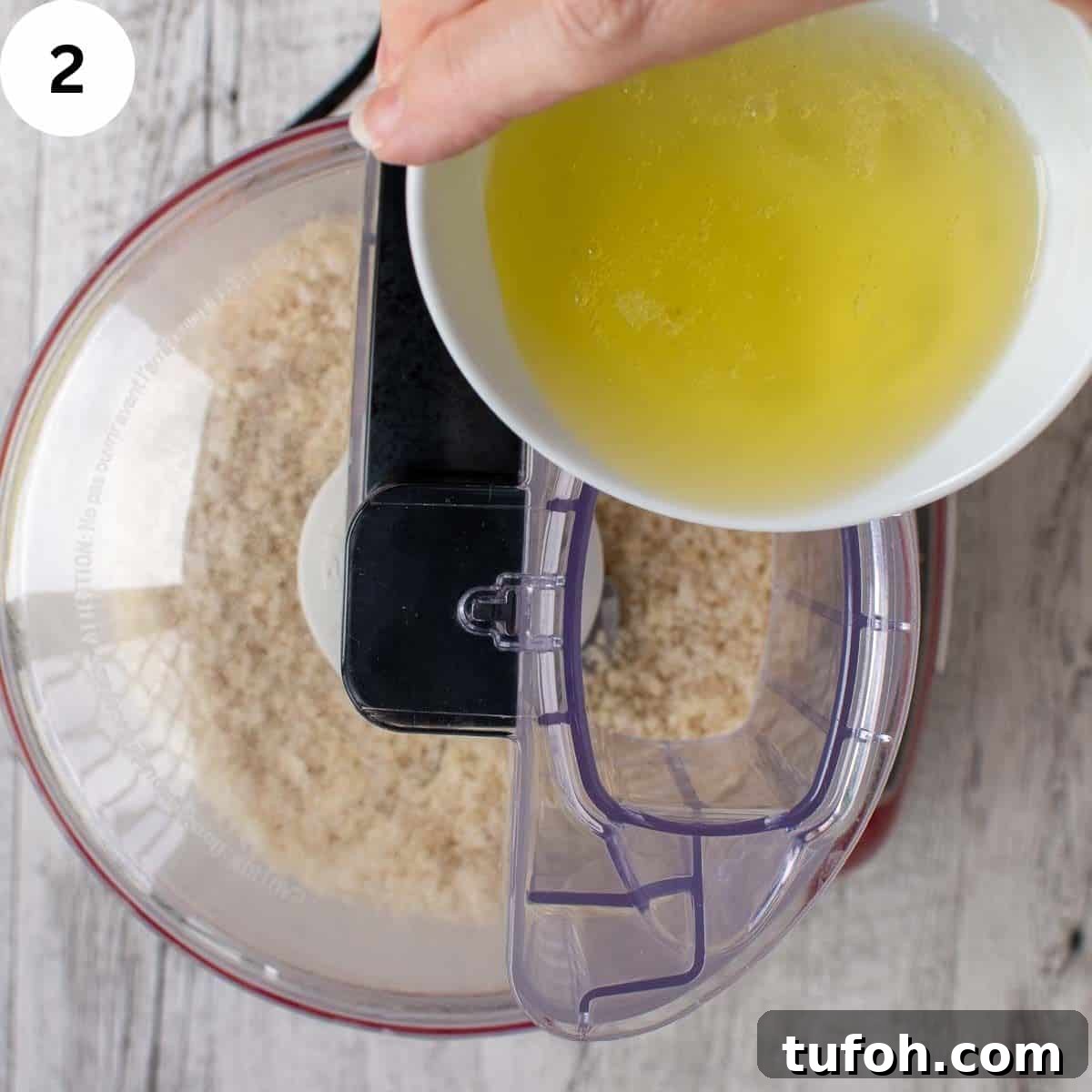 Pignoli Cookies: Classic Italian Almond Macaroon Recipe 5 Egg white being poured into the spout of a food processor.