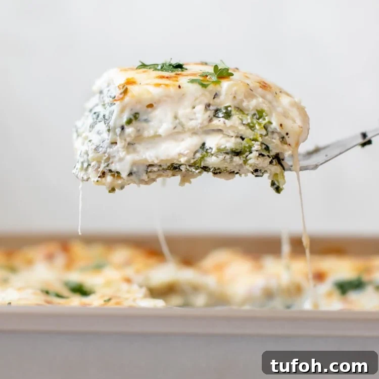a spatula serving a slice of lasagna out of the pan