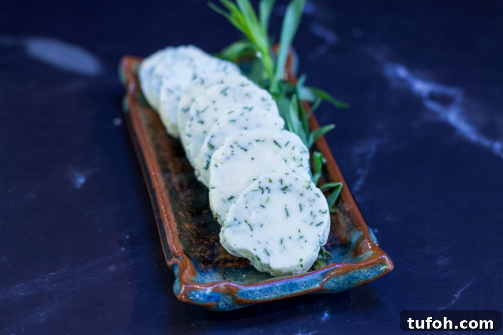 tarragon compound butter on serving tray with sprig of tarragon