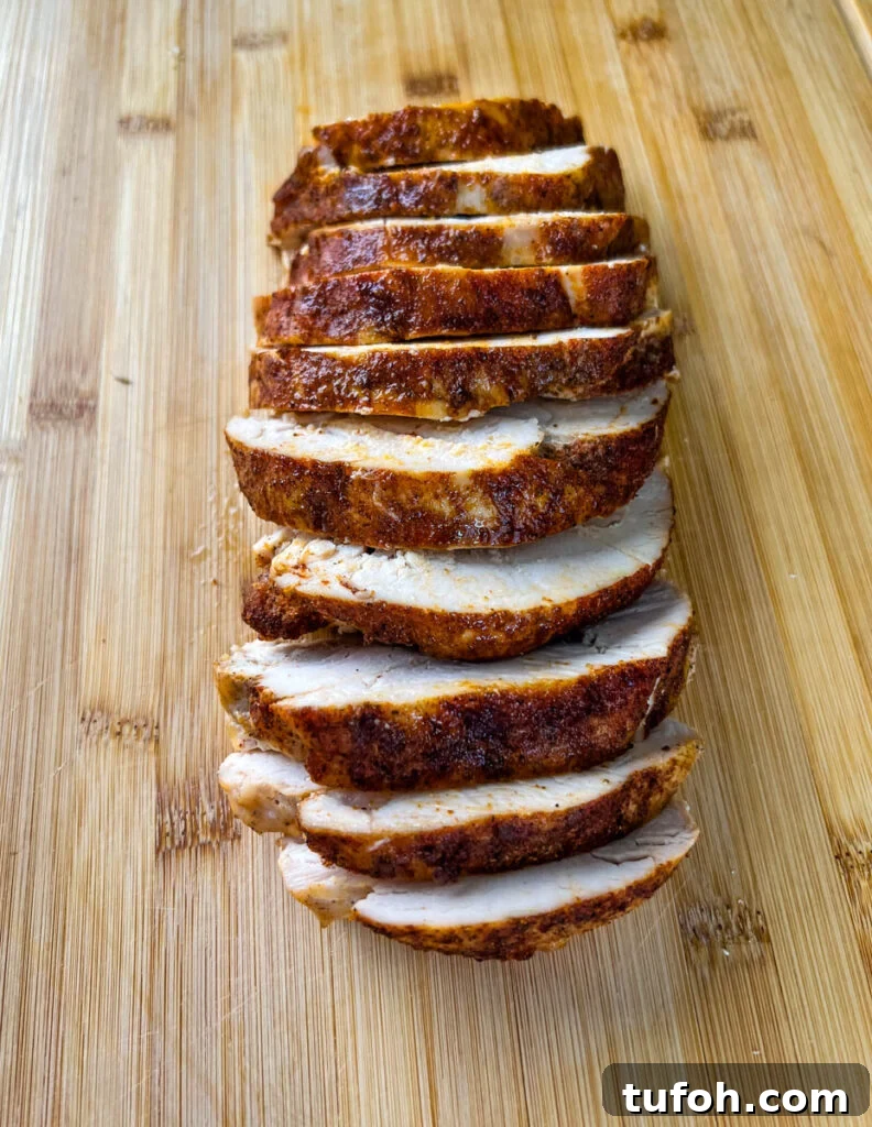 Crockpot Boneless Turkey Breast Recipe for Tender, Juicy Results 7 slow cooker Crockpot boneless turkey breast sliced on a bamboo cutting board