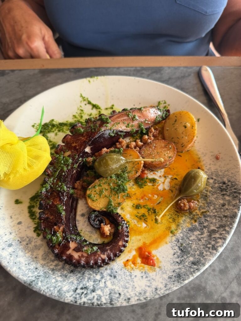 An octopus dish with potatoes and and large capers
