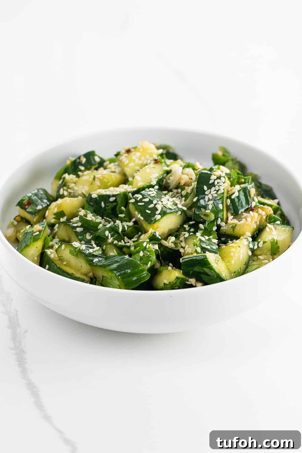 Crisp Smashed Cucumber Salad with Garlic and Sesame Dressing 2 smashed cucumber salad in a bowl